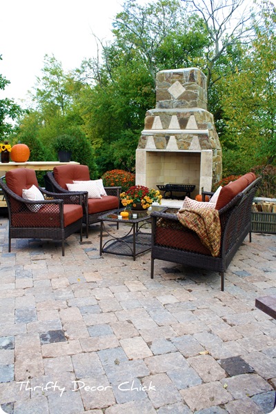 tall outdoor fireplace with chairs