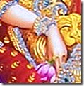 Sita Devi holding a flower