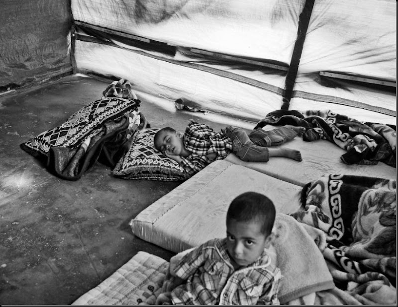 Syrian children inside their family's tent in a settlement in the Bekaa Valley, Lebanon. (Moises Saman/Magnum Photos for Save the Children)