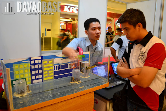 A Computer Engineering student explains their project during AdDU-CEA Technical Exhibit at Abreeza Mall