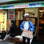 lady holding a sushi menu at tsukiji fishmarket in tokyo in Ginza, Japan 