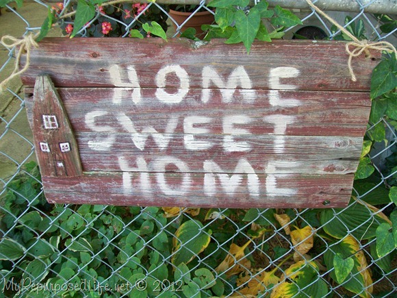 stockade fence repurposed into rustic sign