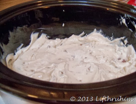 Cream Soup and Sour cream mix covering chicken in crockpot