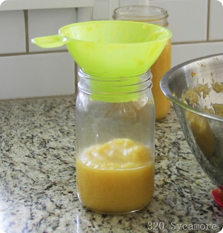 ladle applesauce into jars