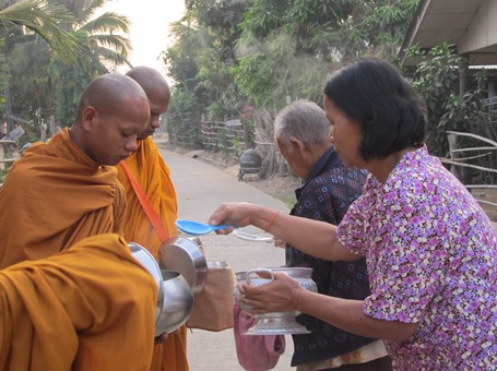 peple giving alms in thailand