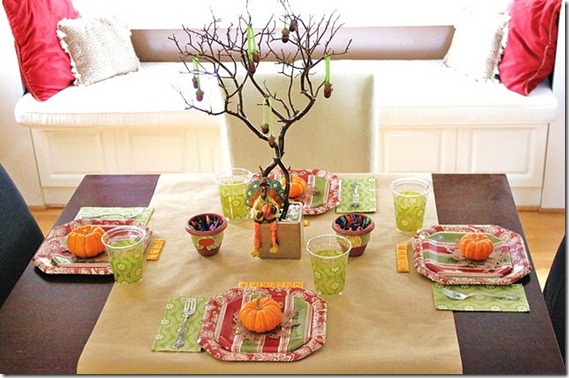 Thanksgiving kids table decorating and activity ideas--colorful table with guessing game and cheese cracker place cards