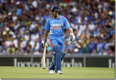 India's Sachin Tendulkar looks over his shoulder as he walks from the field after being run out by Australia's David Warner during their one-day international cricket match