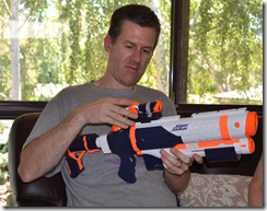 David unwrapping a super-soaker water pistol