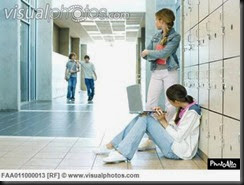 two_high_school_girls_by_lockers_watching_teen_boys_approaching_FAA011000013