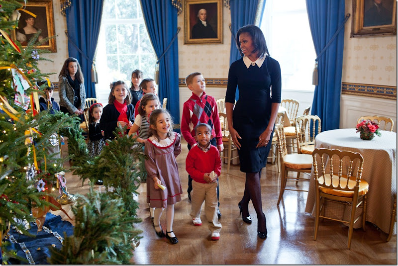 First Lady Michelle Obama walks with children past the official White House Christmas Tree in the Blue Room, Nov. 30, 2011. Mrs. Obama welcomed military families to the White House for for the first viewing of the 2011 holiday decorations. (Official White House Photo by Lawrence Jackson)<br /><br />This official White House photograph is being made available only for publication by news organizations and/or for personal use printing by the subject(s) of the photograph. The photograph may not be manipulated in any way and may not be used in commercial or political materials, advertisements, emails, products, promotions that in any way suggests approval or endorsement of the President, the First Family, or the White House. 