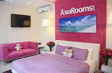 AsiaRooms Pop Up Hotel room stay is Singapore first ever mobile dream vacation guest room glass wall façade comfortable double bed, flat screen LED TV, couch, flowers, magazines, bears, bedroom lights lamp aircon smart modern fitting