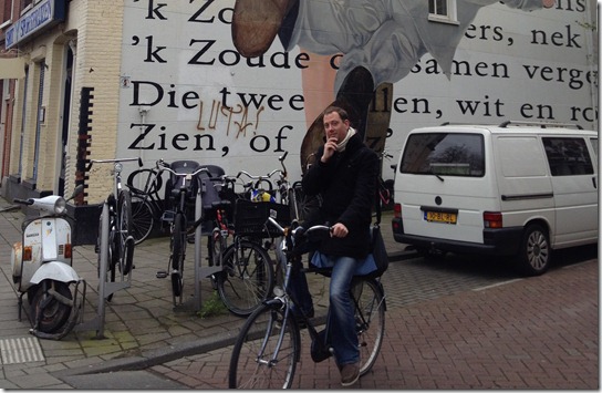 Dirk Eys bicycling in Amsterdam