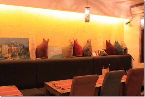 昆山夢田香草，一樓的室內是溫馨的色系，牆壁上還擺了很多隻貓咪造型的抱枕。 