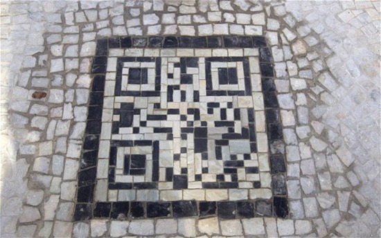A QR codes made of the black and white stones covers a sidewalk near the beach in Rio de Janeiro, Brazil, Friday, Jan. 25, 2013. The QR codes are being placed at tourist spots which can be scanned with a mobile device for information about the site. (AP Photo/Silvia Izquierdo)