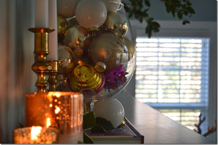 Ornaments in Apothecary Jars and Candles Make for a Cozy Mantel