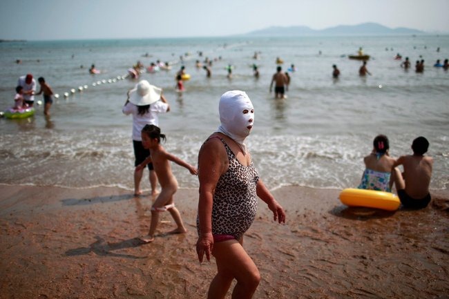 Mature big tit nude sunbathing The Latest Chinese Beach Craze Face Kini Amusing Planet
