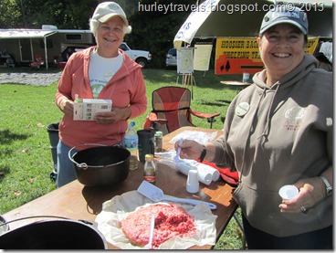 Connie and Yvette making strawberry dessert and chili in the dutch oven.