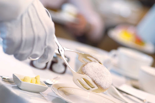 Have a delicious cup of afternoon tea offered by Queen Mary 2's white gloved servers.