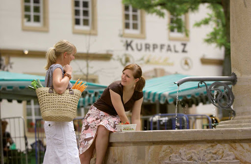 Germany-Konigsplatz-square-fountain - Two women at the fountain in the townsquare of Königsplatz, Germany. 