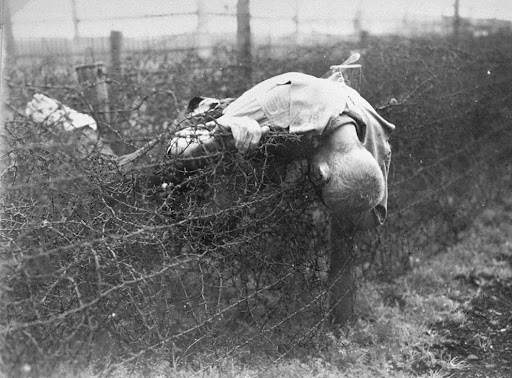 A dead camp prisoner is lying on a barbed wire fence in Leipzig-Thekla, to the south of the Buchenwald camp, in the vicinity of Weimar, Germany