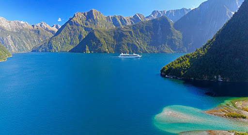 Milford_Sound_ - As a passenger on a cruise ship, you’ll get the ultimate view of Milford Sound. Make yourself comfortable on the promenade deck and just drink it all in. What you’re seeing is the work of successive ice ages, when huge glaciers carved paths to the sea.