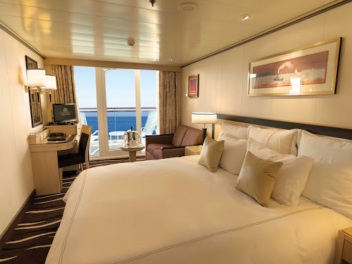 Guests staying in Queen Mary 2's Deluxe Balcony Stateroom get a sitting area with sofa, large closet space, full bathroom and shower.