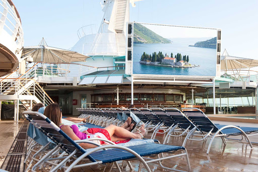 Grandeur-of-the-Seas-outdoor-screen - Watch family-friendly feature films and sporting events on Grandeur of the Seas' 220-square-foot poolside outdoor screen. 