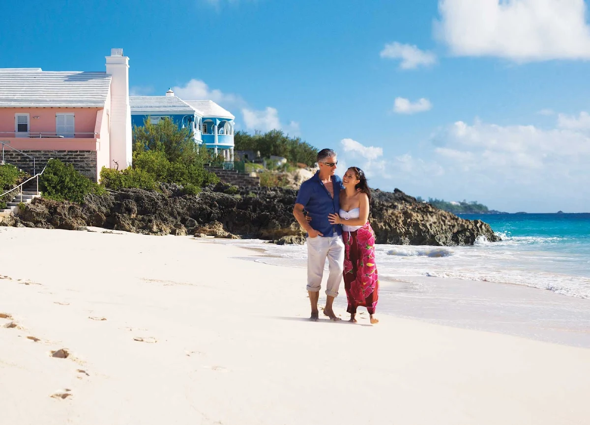 beach-couple-Bermuda - Stroll along some of the beautiful beaches of Bermuda. Bermuda sits far north of the Caribbean Sea off the coast of North Carolina, but the archipelago of 120 islands and islets has a Caribbean soul.