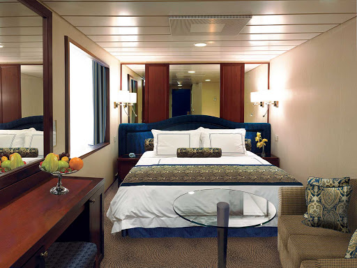 Oceania-E-Ocean-View-Stateroom - Centrally located on deck 6, Oceania's 143-square-foot E Level Ocean View staterooms are awash in natural sunlight from the expansive window. Features include a vanity desk with chair, refrigerated mini-bar,   breakfast table, Bulgari amenities, flat-screen TV with live satellite and twice-daily maid service.