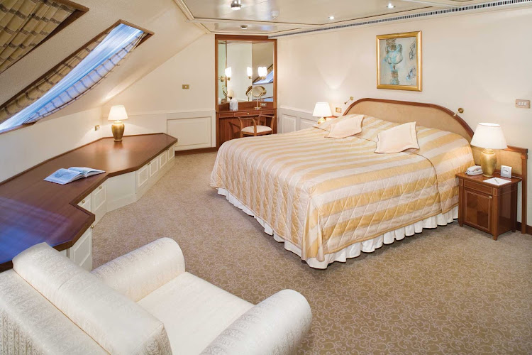 The Grand Suite aboard Silver Whisper has a spacious bedroom that features a queen size bed (or twin beds), sitting area and vanity table with hair dryer.