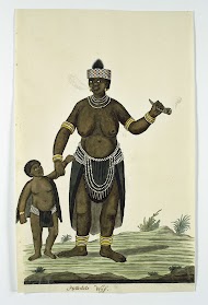 A standing, probably Khoikhoi,  woman, with tobacco-pipe and child