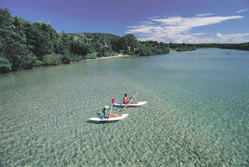 kayaking_South_West_Rocks - Kayakers paddle through turquoise waters at South West Rocks, Kempsey, North Coast NSW, Australia.