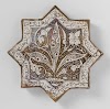 Star-shaped tile with an inscription and floral scrolls