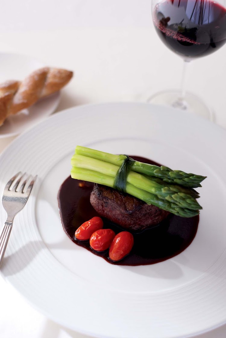 Steak is paired with tomatoes and asparagus for a main entrée aboard Crystal Symphony.