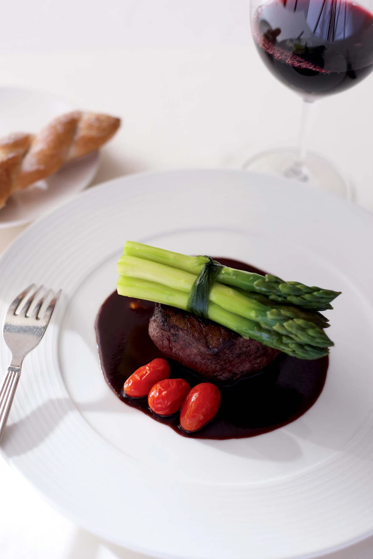 Culinary-Experiences-Steak-Dinner-Entree - Steak is paired with tomatoes and asparagus for a main entrée aboard Crystal Symphony.