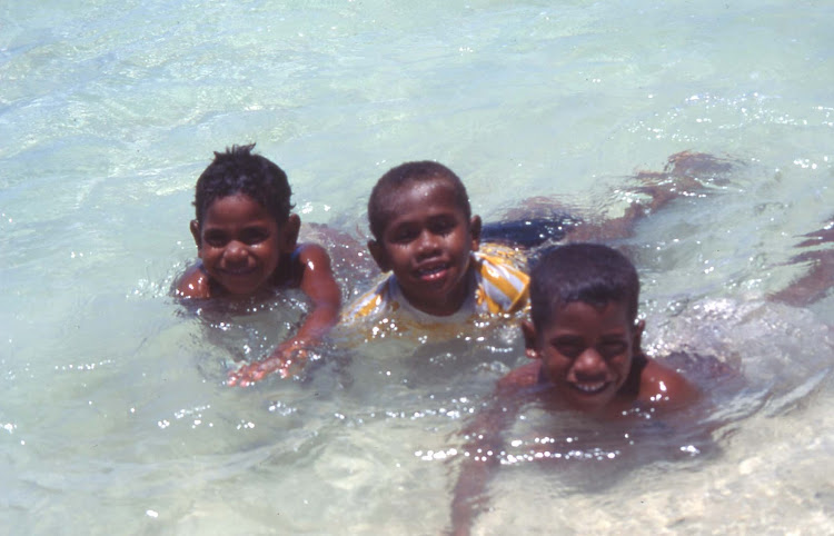 Local children play in the reef in the Yasawa Islands.