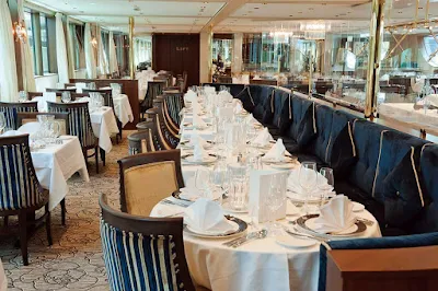 Compass Rose, the main dining room on Tauck's sister river cruise ships Inspire and Savor, boasts panoramic windows and a full menu service for dinner.  