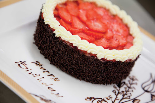 A strawberry and chocolate cake prepared for a special occasion from the kitchen of Queen Mary 2.