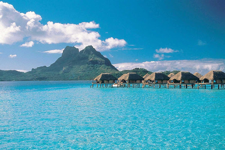 The aquamarine lagoon and bungalows at the Bora Bora Pearl Beach Resort. Some cruise guests come for a day visit, others do an overnight or longer stay. 