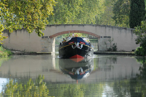 Canal-du-Midi-barge - A peaceful boat ride down the Canal du Midi through the heart of Camargue in Languedoc-Roussillon, southern France. 