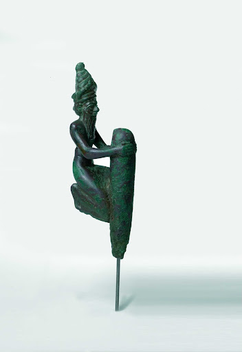 Sumerian foundation figurine depicting a kneeling, god holding a peg Copper