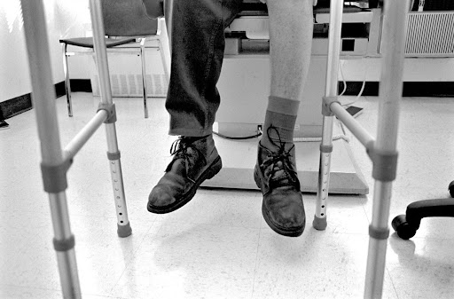 During the doctor's visit, Leonard "Red" Jackson's legs dangle between his walker, New York