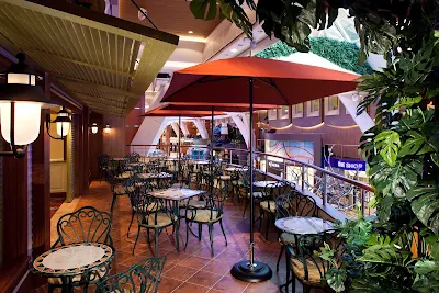 Catch the view out on the terrace in the Diamond Club aboard Allure of the Seas. The cozy retreat offers exclusive 24-hour access for Diamond, Diamond Plus and Pinnacle members.