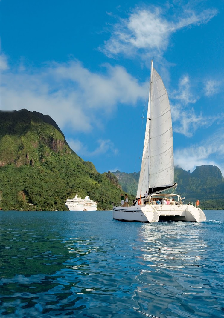 Paul Gauguin guests ply the waters of French Polynesia aboard a catamaran.