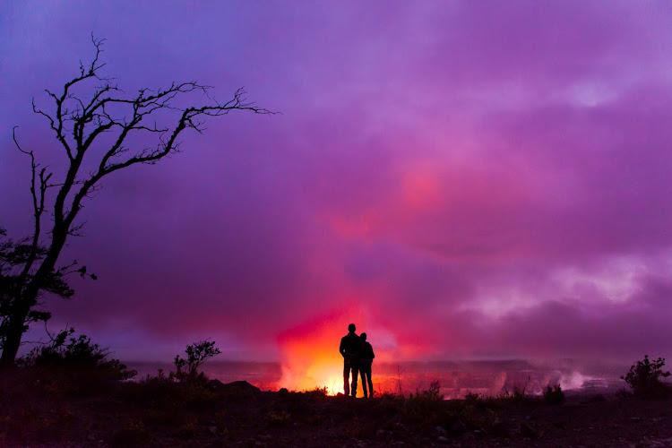 A couple overlooks Halemaumau Crater on the the Big Island of Hawaii. 