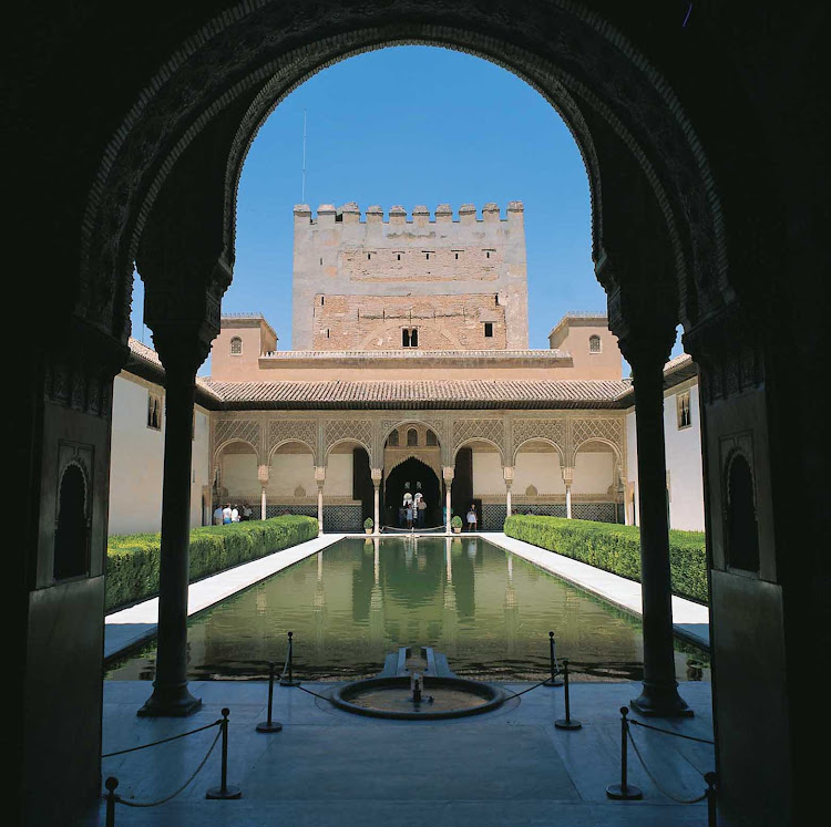 These clear waters at the Court of the Myrtles (Patio de los Arrayanes) are located in the palace complex of historic Alhambra in Granada, Spain. 