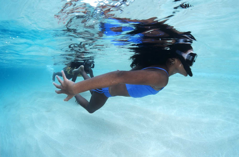 A girl snorkels in the crystal-clear Caribbean waters off Buck Island in St. Croix.