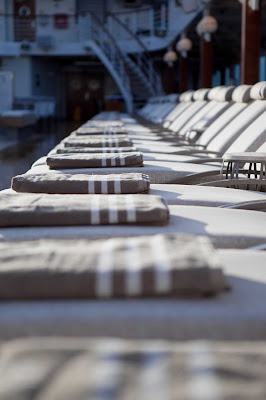 The sun, a breeze and a comfortable chair provide everything you need for an afternoon of relaxing poolside on an Azamara cruise.