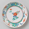 Saucer-dish with flowering plant