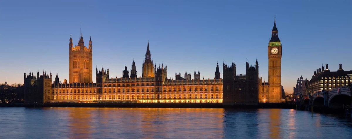Parliament-London - The Palace of Westminster, better known as Parliament, at night as seen from the opposite side of the River Thames in London. Victoria Tower, seat of the House of Lords, is on the left. The Clock Tower of Big Ben and the House of Commons is on the right.     